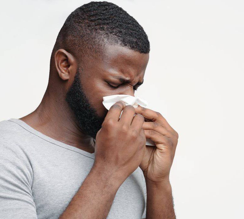 guy-having-runny-nose-touching-his-nose-with-napkins