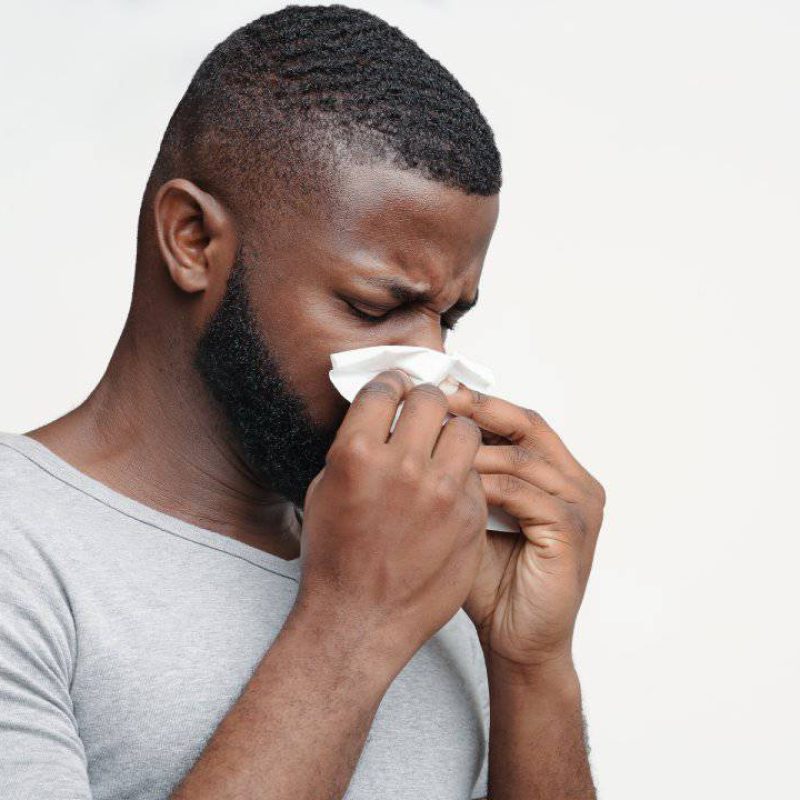 guy-having-runny-nose-touching-his-nose-with-napkins